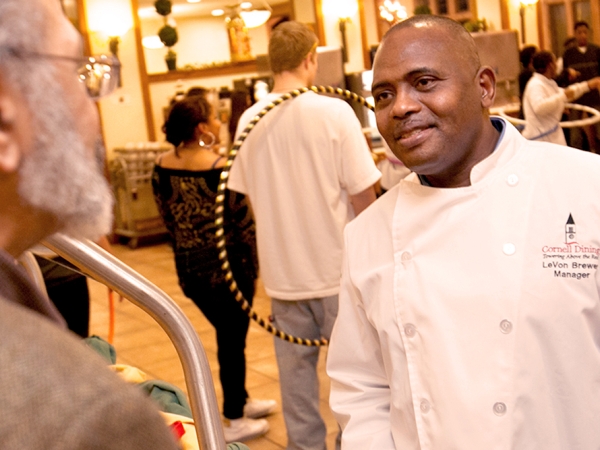 A person speaks to a Cornell Dining manager