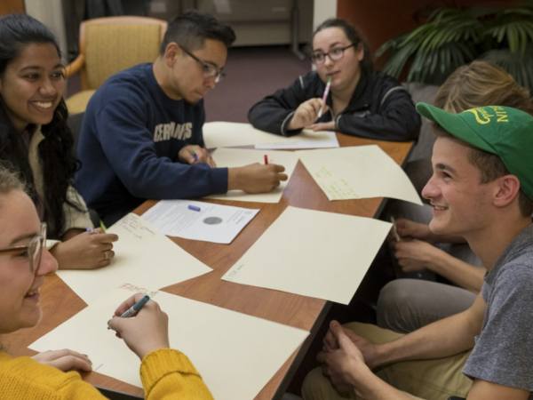 First Generation students seated around a table