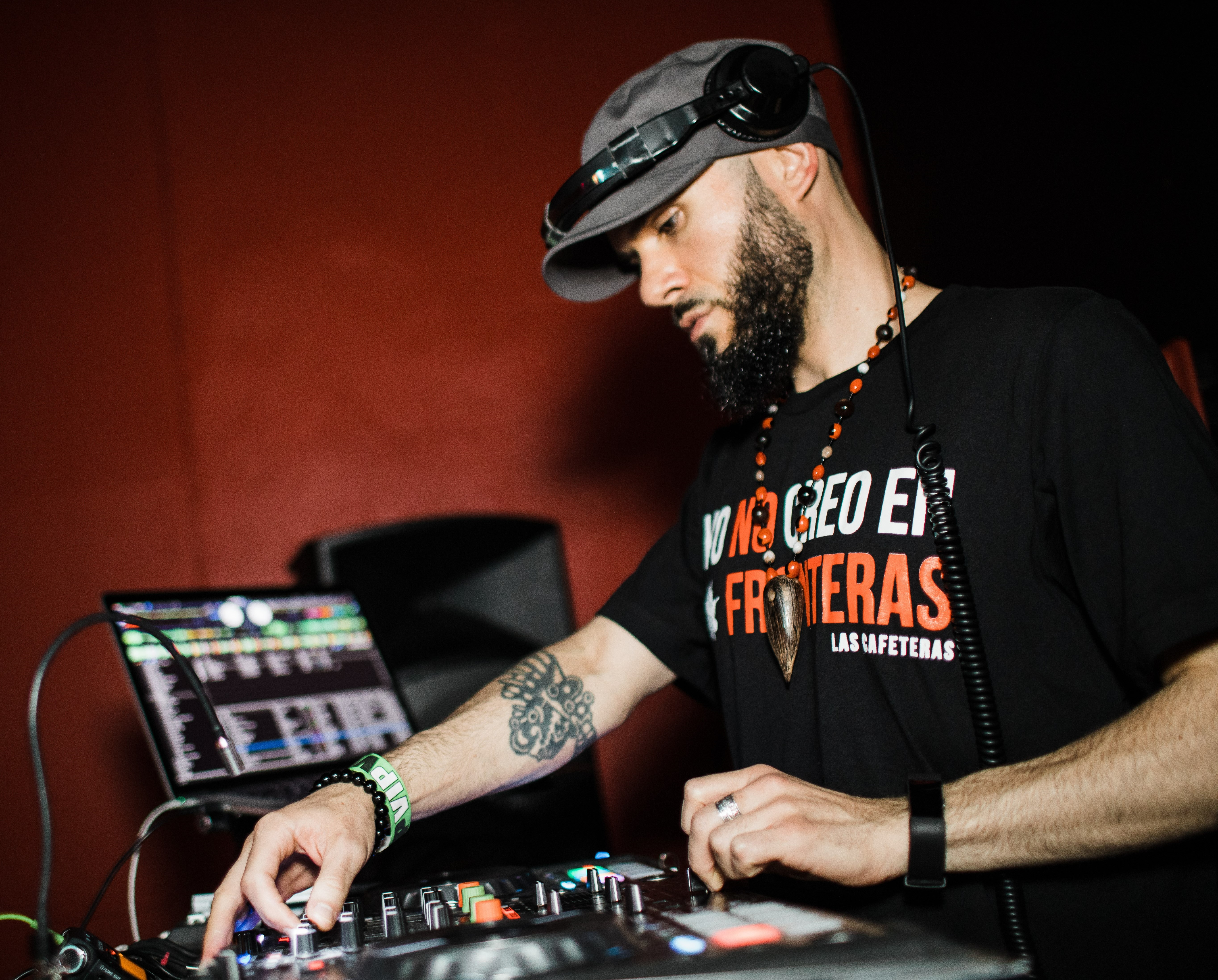 Picture of man adjusting sound on deejay equipment