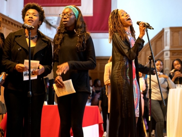 Event co-organizer Wilma Ann Anderson ’92, center, sings with members of the Baraka Kwa Wimbo Gospel Ensemble April 19 at Willard Straight Hall.